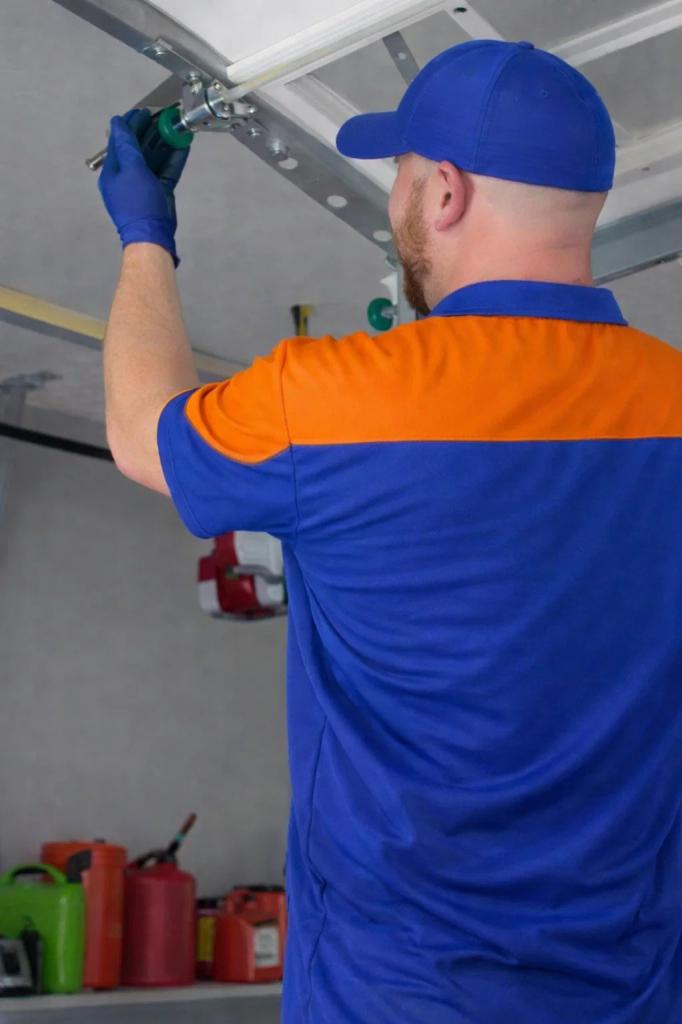 A technician replacing a garage door roller in Windsor, CO