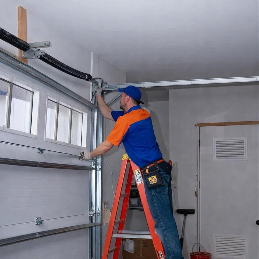 A licensed garage door technician repairing a broken garage spring in Glen Haven, CO